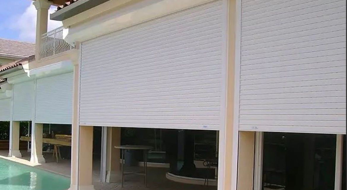 Hurricane shutters on home with pool — hurricane season preparation Quintana Roo