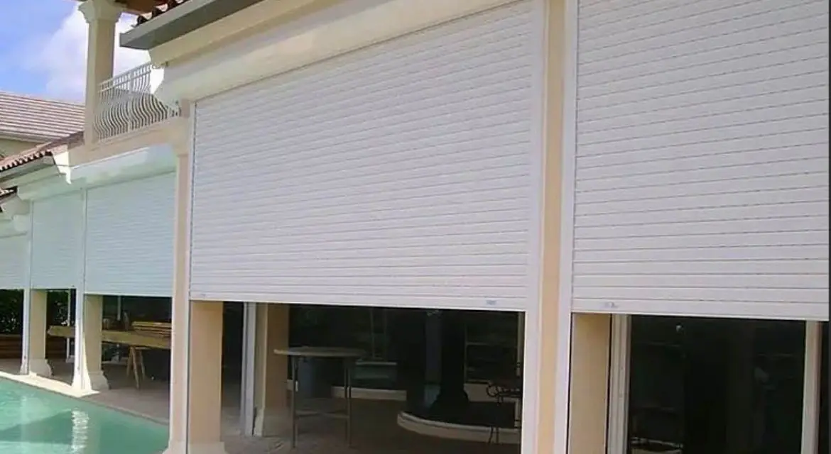 Hurricane roller shutters on luxury home with pool — storm protection